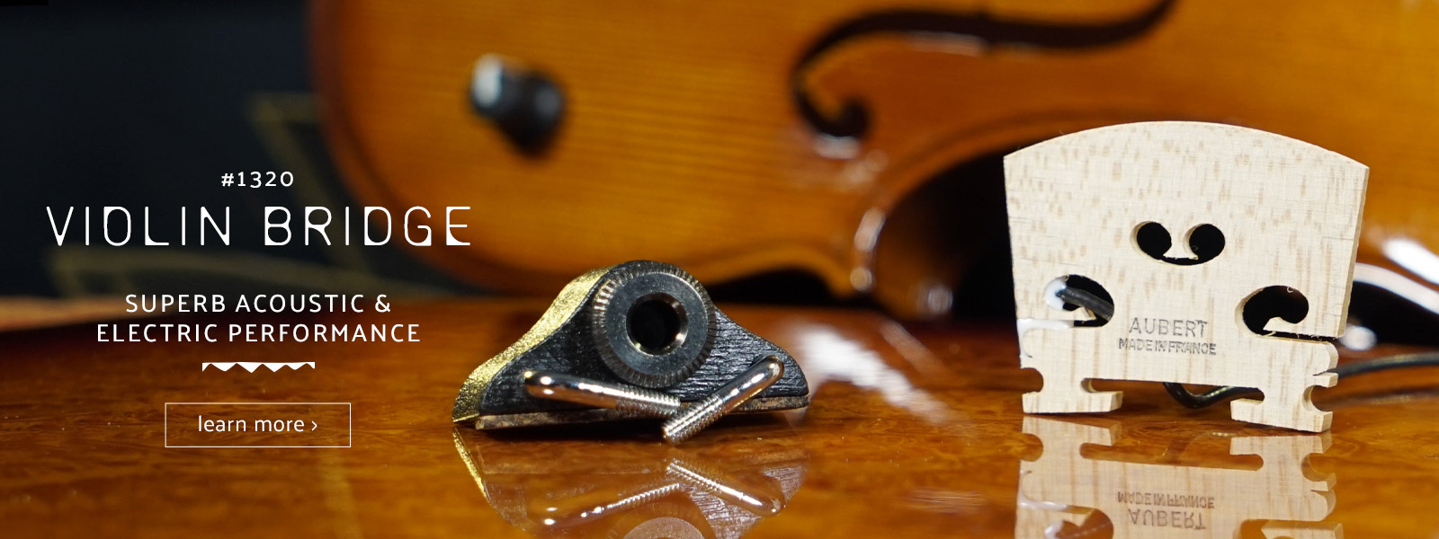 closeup of violin bridge with violin in backgroun
